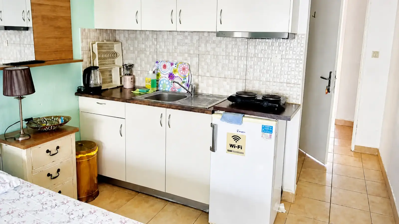Kitchenette in an apartment at Maria Apartments with sink, hob, fridge, kettle and cupboards